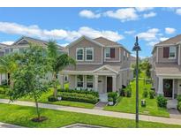 Charming two-story home with manicured lawn, landscaping, and inviting front porch at 1378 Roxy Ln, Winter Garden, FL 34787