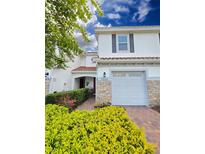 Charming townhome with a one-car garage, colorful landscaping, and a welcoming red tile roof at 14164 Swanley St, Orlando, FL 32832