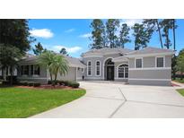 Stunning single-story home with a neutral color scheme, complemented by lush landscaping and a wide driveway at 1441 Foxtail Ct, Lake Mary, FL 32746