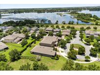 Beautiful aerial view of homes in a lakeside community with well-manicured lawns and mature trees at 15500 Fountain Cove Ct, Winter Garden, FL 34787