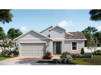 Charming single-story home with a 2-car garage, blue door, and well-manicured landscaping at 1816 Columbus Path, St Cloud, FL 34771
