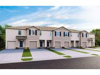 New townhome exteriors with attached garages, enhanced by landscaping and contemporary design features at 200 Feltrim Reserve Blvd, Davenport, FL 33837