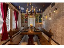 Unique dining room features stone walls, floating candles and a rustic wooden table with bench seating at 2041 Lacie Jo Ln, Kissimmee, FL 34743