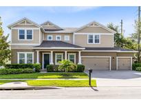 Charming two-story home with a well-manicured lawn and a three-car garage at 2071 Remembrance Ave, St Cloud, FL 34769
