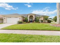 Charming single-story home boasts mature landscaping, a well-manicured lawn, and an attached two-car garage at 3808 Ocita Dr, Orlando, FL 32837