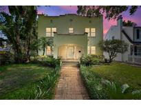 Charming home with beautiful landscaping, a brick pathway, and a cozy front porch at 501 Richmond St, Orlando, FL 32806