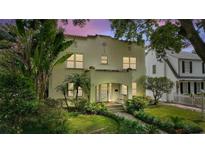 Charming two-story home with a lush front yard and a classic Mediterranean-style design, showcasing the home's curb appeal at 501 Richmond St, Orlando, FL 32806