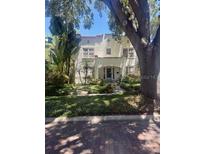 Charming two-story home with stucco facade, red tile roof, and mature landscaping creating a serene ambiance at 501 Richmond St, Orlando, FL 32806