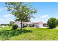 Charming single-story home with a large front yard and mature tree, creating a welcoming curb appeal at 5439 E Sacramento Ct, Orlando, FL 32821