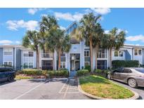 Inviting condo building with palm trees, and well-maintained landscaping at 711 Sugar Bay Way # 109, Lake Mary, FL 32746