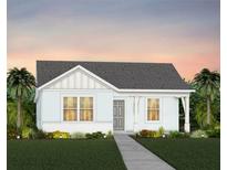 Charming single-story home with light blue siding, gray roof, and beautifully manicured front lawn at 7408 Olivewood Ave, Orlando, FL 32829