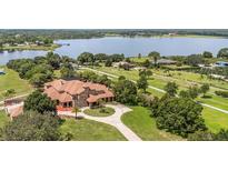 Expansive lakefront estate with lush landscaping, circular drive, and stately architecture at 9400 Laws Road, Clermont, FL 34714