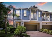 Charming two-story townhouse featuring a private balcony and a convenient attached two-car garage at 995 Grand Wildmere, Longwood, FL 32750