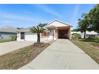 Charming single-story home with a well-maintained front yard and a spacious two-car garage at 1752 Challenger Ave, Davenport, FL 33897