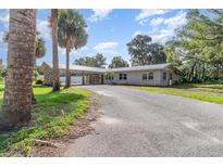Quaint single story home with attached carport on sprawling property at 123 Se 1St Ave, Webster, FL 33597
