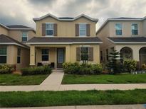 Charming two-story home with well-manicured lawn and inviting front entrance at 129 Boydfield Ln, Davenport, FL 33837