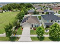 Well-maintained single-story home boasts solar panels, manicured lawn, and fenced yard in a friendly neighborhood at 1565 Diamond Loop Dr, Kissimmee, FL 34744