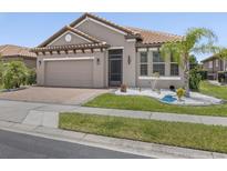 Charming single-story home with a well-maintained front yard and lush landscaping at 1709 Benoit Ter, Davenport, FL 33837