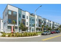 Modern townhome exteriors featuring contemporary designs, colorful accents, and landscaped surroundings at 2018 Packing District Way, Orlando, FL 32804