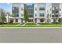 Modern townhomes boast striking architecture, lush landscaping, and inviting entryways at 2290 Brix Sts, Orlando, FL 32804
