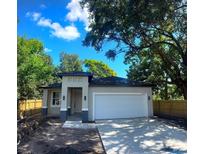 Charming single-story home featuring a two-car garage, covered entry, and a freshly poured concrete driveway at 4409 W Gore Ave, Orlando, FL 32811