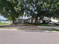 Charming home with mature trees and well-manicured landscaping at 8603 Snowfire Dr, Orlando, FL 32818