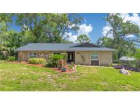 Charming single-story home featuring stone accents, mature landscaping, and a welcoming front entrance at 1200 Ridge Rd, Longwood, FL 32750