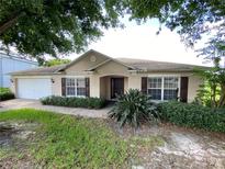 Charming single-story home with well-maintained landscaping and a two-car garage at 1227 Juniper Hammock St, Winter Garden, FL 34787