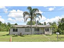 Charming single-story home featuring a well-maintained lawn and inviting curb appeal at 1390 E Airport Blvd, Sanford, FL 32773