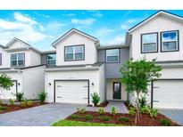 Charming new construction two-story townhouse with white and gray exterior paint scheme at 1537 Heritage Pl, Oviedo, FL 32765