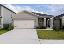 Charming single-story home featuring a neutral color palette and a spacious two-car garage at 1792 Bull Hill Rd, Kissimmee, FL 34744