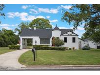 Charming home featuring unique architectural elements and well-maintained landscaping at 2101 Lily Ct, Sanford, FL 32771