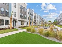 Beautiful townhome community with manicured landscaping, palm trees, and modern architecture at 2217 Valentine Aly, Orlando, FL 32804