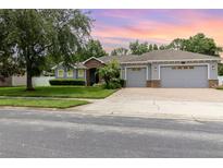 Charming single-Gathering home featuring a well-manicured lawn and a three car garage at 2588 Gabrielle Woods Pl, Oviedo, FL 32765