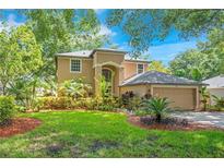Beautiful two-story home with a well-manicured lawn and mature landscaping at 2794 Cullens Ct, Ocoee, FL 34761