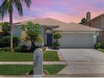 Charming one-story home featuring a well-maintained lawn and a two-car garage at 3713 Becontree Pl, Oviedo, FL 32765