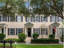Charming townhome with neutral paint, black shutters, and mature trees in a lush community at 4709 Fox St, Orlando, FL 32814