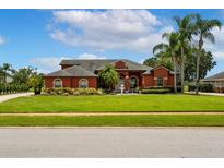 Charming one-story home with well-manicured lawn, mature palm trees, and vibrant landscaping at 5306 Crane Hill Ct, St Cloud, FL 34771
