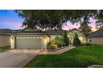 Charming single-story home featuring a well-manicured lawn and an attached two-car garage at 544 Lake Sumner Dr, Groveland, FL 34736