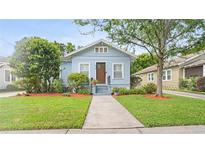 Charming light blue single-story home with well-manicured lawn and front yard at 638 Clayton St, Orlando, FL 32804