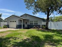 Well maintained single-story home features a lush green lawn and mature landscaping at 2315 Pembrook Dr, Orlando, FL 32810