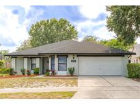 Charming single-story home features a well-maintained lawn, neutral paint, and a two-car garage at 1005 Black Willow Dr, Oviedo, FL 32765