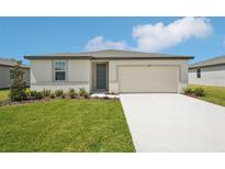 Charming single-story home with a well-manicured lawn and a two-car garage in a suburban neighborhood at 1349 Oak Valley Dr, Auburndale, FL 33823