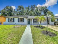 Charming single-story home with a well-maintained lawn, a walkway, and a welcoming front porch at 2109 Hartwell Ave, Sanford, FL 32771