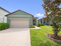 Charming one-story home featuring a two-car garage, manicured lawn, and inviting curb appeal at 2249 Litchfield Loop, Deland, FL 32720