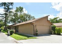 Charming single-story home featuring an attached garage and a well-maintained lawn and landscaping at 271 Raintree Dr, Casselberry, FL 32707