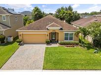 Charming single-story home with a well-manicured lawn and a paved driveway at 2733 Big Timber Dr, Kissimmee, FL 34758