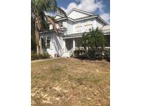 Charming two-story home with manicured landscaping and a welcoming front porch at 310 W Lake Ave, Auburndale, FL 33823