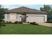 Charming one-story home with a well-manicured lawn and neutral-colored exterior with attached two car garage at 3117 Legends Preserve Dr, Daytona Beach, FL 32124