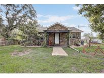 Charming stone-clad home featuring a brick walkway and covered front porch at 369 Bluff Lake Rd, Mascotte, FL 34753